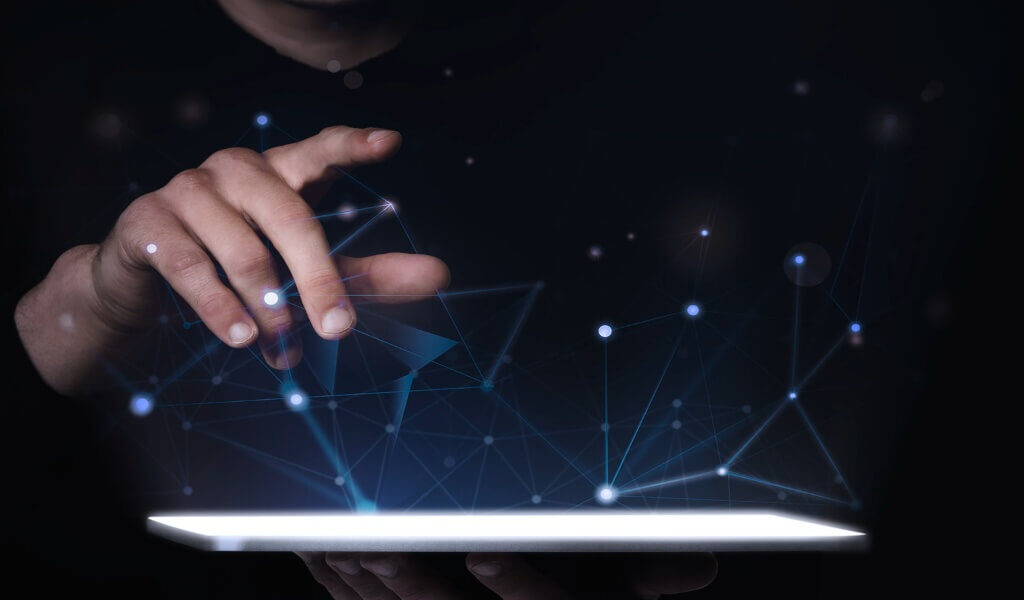 Man using a digital tablet, representing the integration of new digital tools into business processes - RabIT Solutions